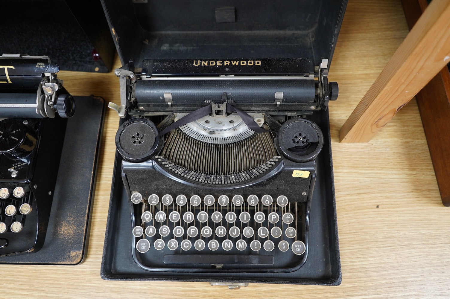 A Peoples Champion Indexing Typewriter, circa 1893, by the Garvin Machine Co., New York, on a mahogany plinth, with black tin cover, inscribed ‘’PEX’’ CHAMPION, width 28cm; a Bar-Let vintage typewriter, cased; an Underwo